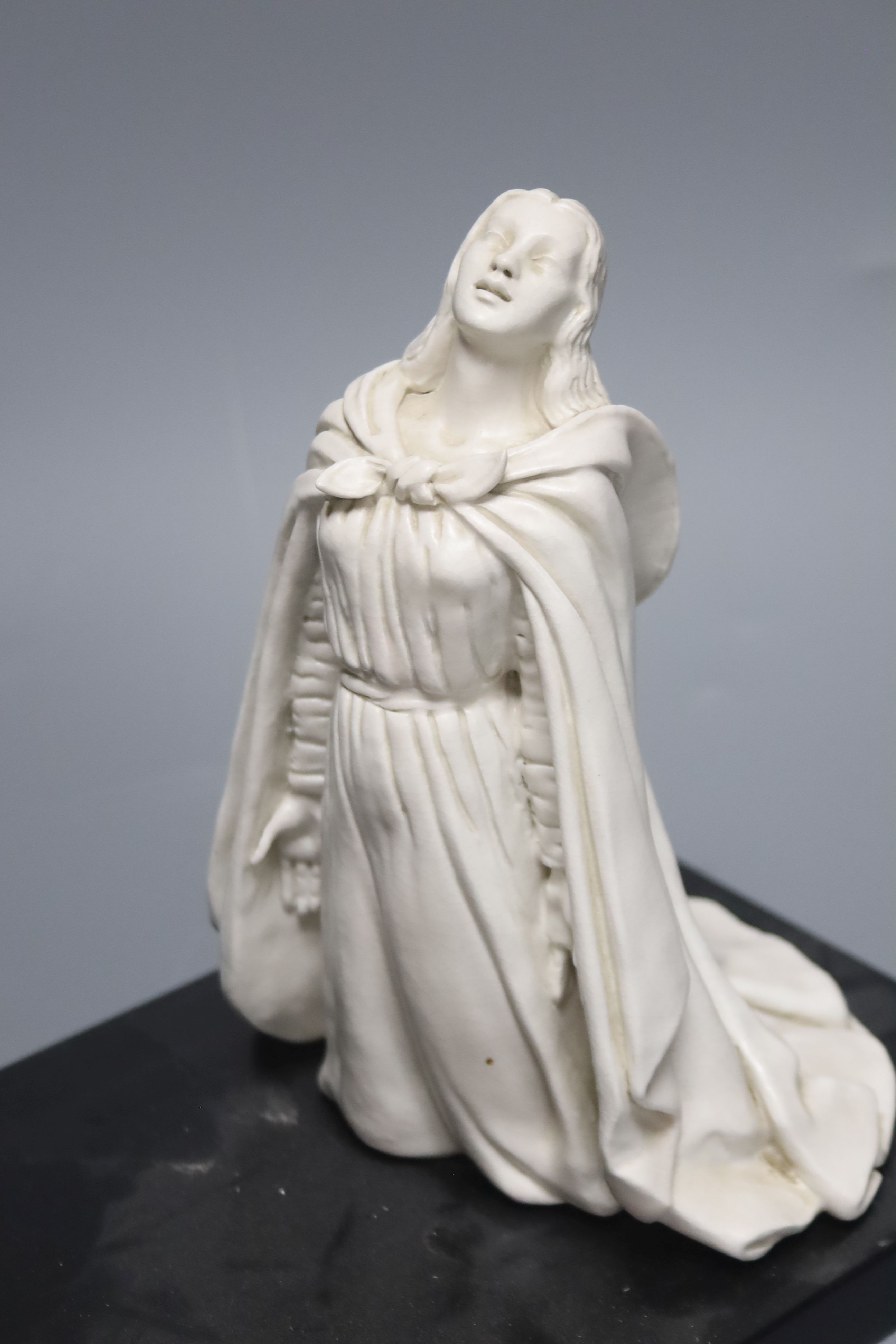 B.Henry 1956. A ceramic group 'The Annunciation', on stand, length 40cm